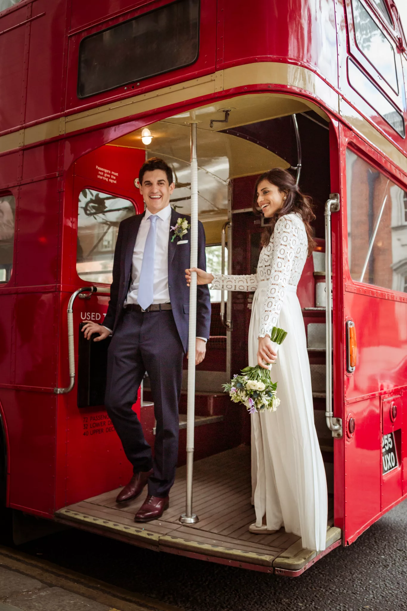 Wedding at Chelsea Old Town Hall London, red double decker bus Routemaster to reception at Winemakers Club Holborn