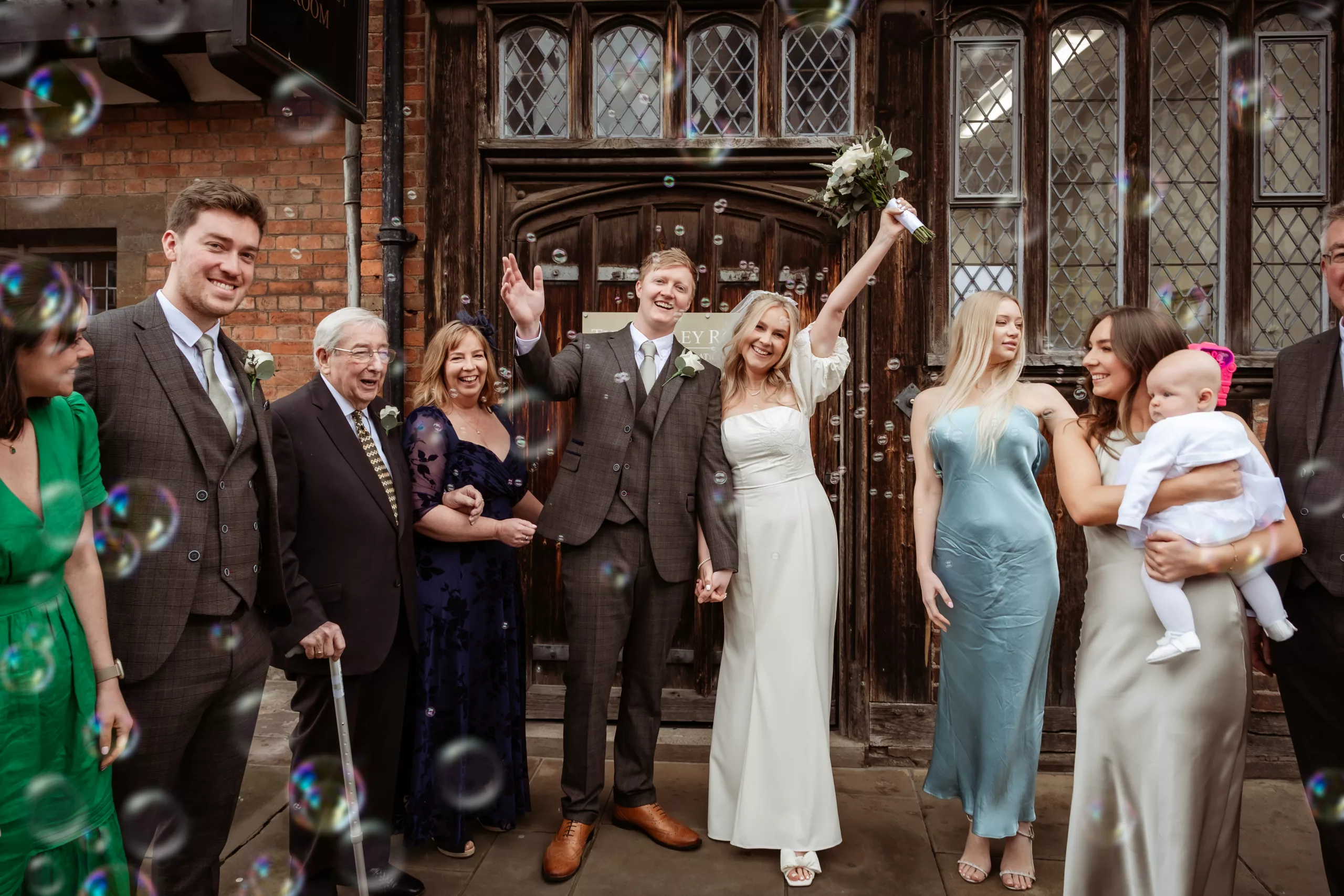 Bride and groom exiting the Henley Room register office in Stratford upon Avon with bubbles instead of confetti